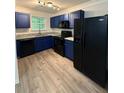 Beautiful kitchen features striking blue cabinets, modern appliances, and stunning granite countertops at 1700 Devon Sw Dr, Atlanta, GA 30311