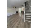 Spacious living room featuring hardwood floors, fireplace, and a ceiling fan for optimal comfort at 1700 Devon Sw Dr, Atlanta, GA 30311