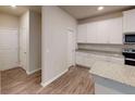 Modern kitchen with white cabinets, granite countertops, and stainless steel appliances at 3 Roving Hills Cir, Cartersville, GA 30121