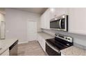 Modern kitchen with white cabinets, granite countertops, and stainless steel appliances at 3 Roving Hills Cir, Cartersville, GA 30121