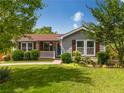 Well-maintained single-story home with lush green lawn, mature trees, and charming curb appeal at 445 Brownell Ave, Scottdale, GA 30079