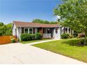 Inviting single-story home with beautiful landscaping and a quaint front porch at 445 Brownell Ave, Scottdale, GA 30079