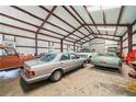 Spacious metal outbuilding interior with concrete floor, multiple vehicles, and ample storage space at 829 Christopher Rd, Sharpsburg, GA 30277