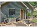 Inviting front porch with galvanized planters, rock border, and natural light at 1650 Tomahawk Trl, Cumming, GA 30041