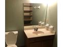Bathroom featuring a corner sink vanity, large mirror, and shelving, next to the toilet at 286 Toweridge Sw Dr # 3, Marietta, GA 30064