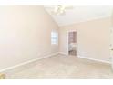 Spacious bedroom with neutral walls, plush carpeting, and natural light from a window at 421 Old Ivy Path, Mcdonough, GA 30253