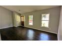 Inviting living room featuring hardwood floors and two windows allowing for natural light at 4827 Wyndam Dr, Stone Mountain, GA 30088