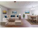 Staged living room showcasing an open floor plan, hardwood floors, and stylish decor at 5509 Covent Way, Lithonia, GA 30058