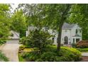 This home features a two-car garage and a meticulously maintained lawn and shrubbery, enhancing its appeal at 341 Lands Se Ml, Marietta, GA 30067