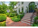 Elegant brick steps leading to a home's grand arched front door, surrounded by decorative landscaping at 341 Lands Se Ml, Marietta, GA 30067