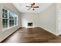 Bright living room featuring a fireplace, large window, and beautiful hardwood floors at 617 Kyles Cir, Hiram, GA 30141