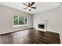 Bright living room featuring a fireplace, hardwood floors, and a large window offering natural light at 617 Kyles Cir, Hiram, GA 30141