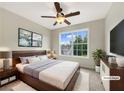 Cozy main bedroom with a ceiling fan, large window, and calming decor at 617 Kyles Cir, Hiram, GA 30141