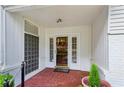 Inviting front porch with brick flooring and a decorative front door, providing a warm welcome to the home at 88 Karland Nw Dr, Atlanta, GA 30305