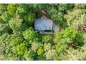 A bird's-eye view of a secluded home surrounded by mature trees and lush greenery at 525 Watergate Ct, Roswell, GA 30076