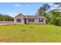 Inviting one-story home with a green lawn and classic design elements at 159 Cranbrooke Dr, Dallas, GA 30157