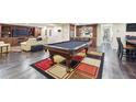 Finished basement with a pool table, bar area, and ample seating, perfect for recreation and entertaining guests at 2460 Due West Nw Cir, Kennesaw, GA 30152