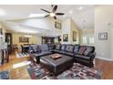 Open-concept living room featuring a vaulted ceiling, skylights, and hardwood floors, ideal for entertaining and relaxation at 2460 Due West Nw Cir, Kennesaw, GA 30152