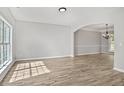 Spacious living room features new floors, neutral walls, and an open archway into the dining room at 463 The Gables Dr, Mcdonough, GA 30253