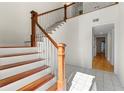 Bright foyer showcasing staircase with hardwood steps and decorative iron railing at 1622 Executive Park Ne Ln, Atlanta, GA 30329