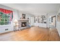 Bright living room with hardwood floors, a brick fireplace, built-in bookshelves, and large windows at 2855 Cedar Canyon Ct, Atlanta, GA 30345