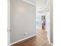 Entryway hallway with wood floors and view into the open concept living areas at 607 Tall Timbers, Woodstock, GA 30188