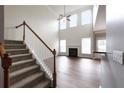 Bright living room with tall ceilings, a fireplace, and stairs at 607 Tall Timbers, Woodstock, GA 30188