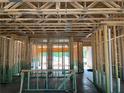 Interior view displaying the wooden frame of a new home under construction, highlighting the layout at 1406 Lucan Nw Ln # Wc221, Lawrenceville, GA 30043
