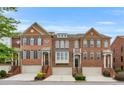 Attractive townhomes boast brick facades, arched windows and attached garages at 2513 Friar Tuck Se Ln # 1, Atlanta, GA 30339
