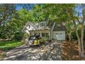 Inviting home with an attached garage and a vintage yellow car in the driveway at 2517 Birchwood Ne Dr, Atlanta, GA 30305