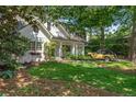 Beautiful home with a lush lawn and mature trees, and a unique vintage car at 2517 Birchwood Ne Dr, Atlanta, GA 30305