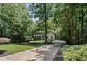 Secluded home on a wooded lot with long driveway and mature trees offers privacy and tranquility at 2535 Hampton Trl, Cumming, GA 30041