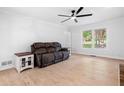 Bright living room with wood-look floors, a large window, and a comfortable seating area at 3078 Milford Chase Sw, Marietta, GA 30008