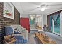 Cozy sun room features exposed brick wall, neutral carpet, and access to the yard at 200 Dogwood Dr, Canton, GA 30114