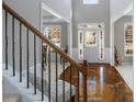 Inviting foyer with gleaming wood floors and staircase leading to the upper level at 2430 Redbud Meadow Ln, Douglasville, GA 30135