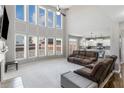 Bright living room boasts soaring windows, neutral decor, and an open floorplan to the kitchen at 2430 Redbud Meadow Ln, Douglasville, GA 30135