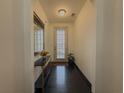 Elegant entryway featuring dark wood floors, stylish console table, mirror, and plenty of natural light at 3318 Sardis Bend Dr, Buford, GA 30519