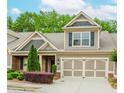 Beautiful home with a well-kept lawn, a two-car garage, and appealing architectural details at 1555 Water Vista Ct # 4102, Cumming, GA 30041