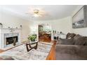 Bright living room with hardwood floors, fireplace, and views into the adjacent dining area at 3161 Pagoda Trce, Lawrenceville, GA 30043