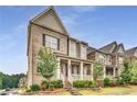 Side view of a well-maintained home with a covered porch, brick and siding exterior, and landscaped front yard at 4831 Miller Hill Rd, Buford, GA 30518