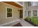Close-up of unit entrance featuring a brown door, and garden view at 307 Berkeley Woods Dr, Duluth, GA 30096