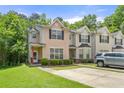 Two-story townhome featuring well-maintained lawn and convenient parking at 7331 Wagon Wheel Ct, Jonesboro, GA 30236