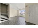 Inviting living room with bright natural light, tile floors, and staircase at 7331 Wagon Wheel Ct, Jonesboro, GA 30236