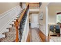 Elegant staircase features hardwood floors, a decorative runner, and wrought iron railings at 133 Parkway Dr, Fairburn, GA 30213