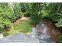 Aerial view of large, fenced backyard with mature trees and a storage shed at 4504 Reva Ne Way, Marietta, GA 30066