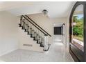 Elegant foyer showcasing a staircase with black banister and mosaic tile flooring at 2912 Vinings Forest Se Way, Atlanta, GA 30339