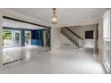 Open-concept living space featuring marble floors, staircase, and access to outdoor balcony at 2912 Vinings Forest Se Way, Atlanta, GA 30339