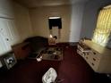 An interior shot of a bedroom showing dated decor and clutter at 158 Milton Sw Ave, Atlanta, GA 30314