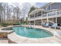 Backyard oasis features a large pool, surrounding patio, and outdoor seating area at 210 Little River Farms Trl, Canton, GA 30115