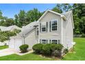 Two story home featuring traditional curb appeal, trimmed lawn, and a two-car garage at 2743 High Tide Dr, Atlanta, GA 30349